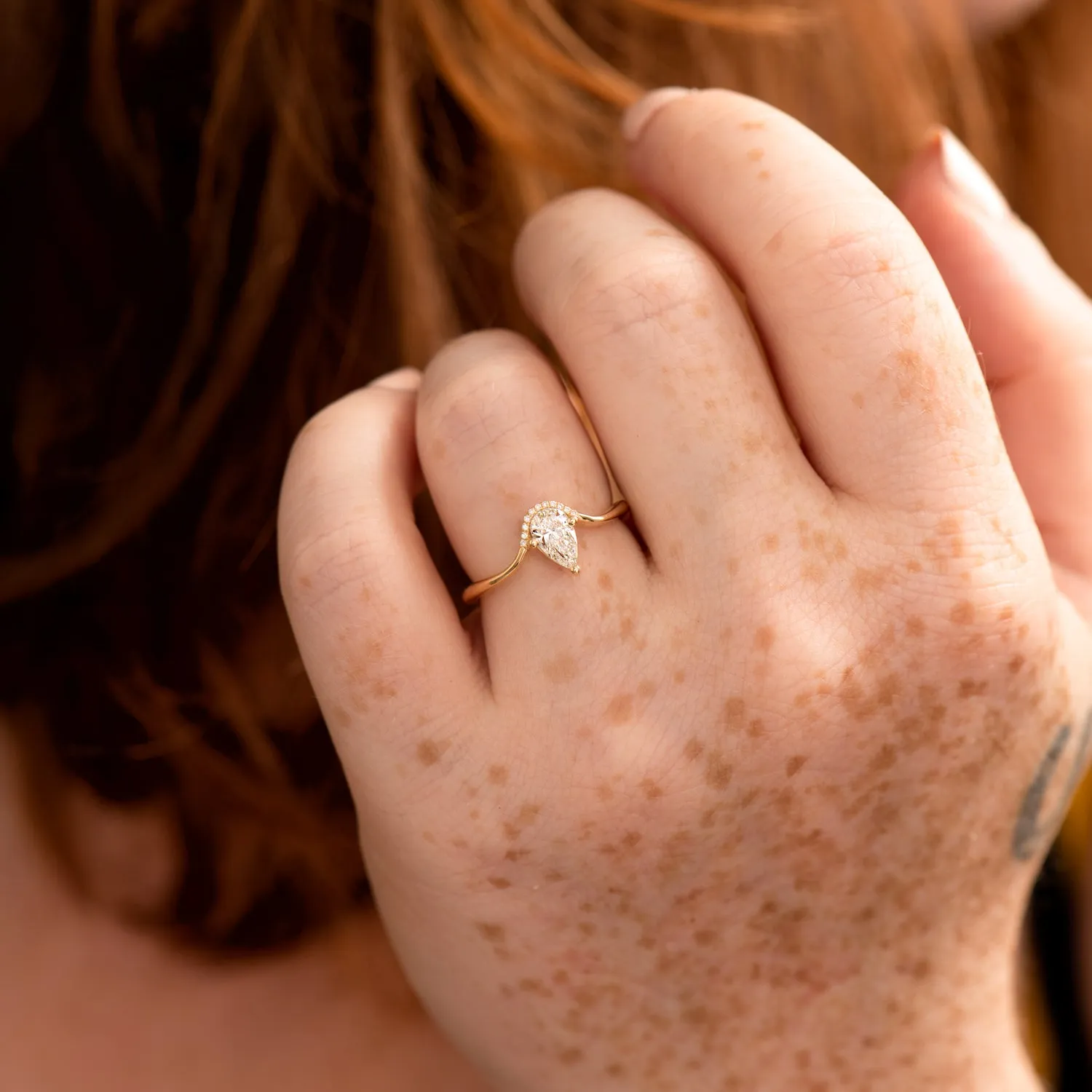 Floating Pear Cut Diamond Engagement Ring in a Classic Style